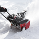 Man removing snow after storm with a snowblower