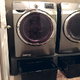 washer and dryer on pedestal with bins