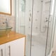 A standing shower with a fiberglass interior.