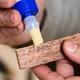 A man uses wood glue.