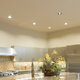 A kitchen with recessed lighting.