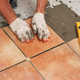 installing ceramic tile on the floor.