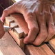 hands cutting corner joints in wood
