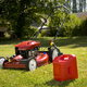 lawn mower and gas can on the grass