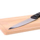 A butcher block with a knife on it.