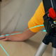 hands using laser measurement tool