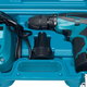 An electric drill in a blue container.