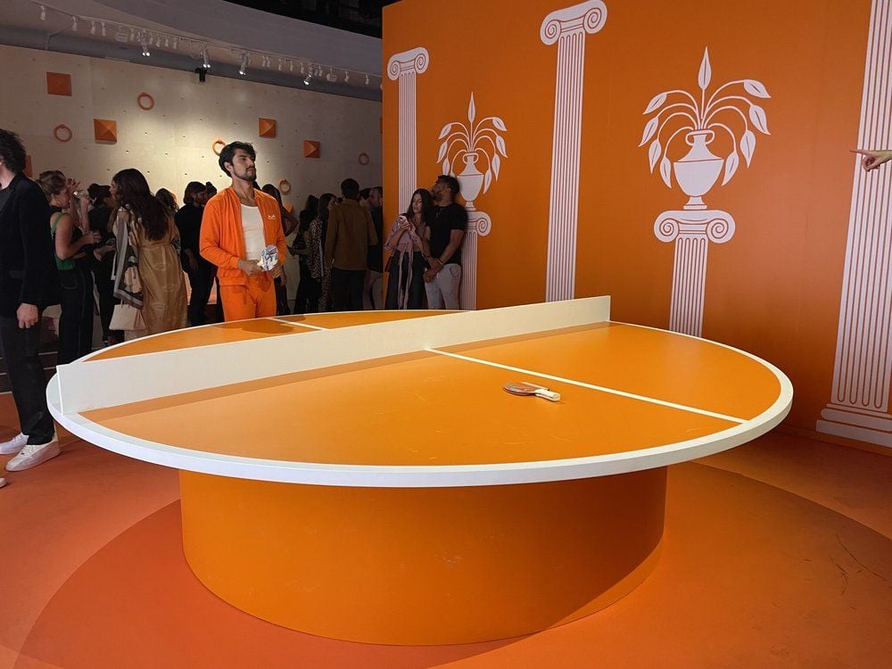 Circular orange ping-png table inside the LA Hermèsfit pop-up gym.