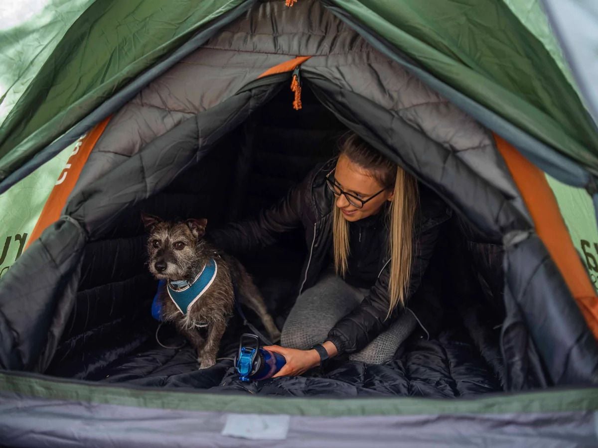 Woman and her dog take shelter inside their ultra-insulated Crucoon tent.