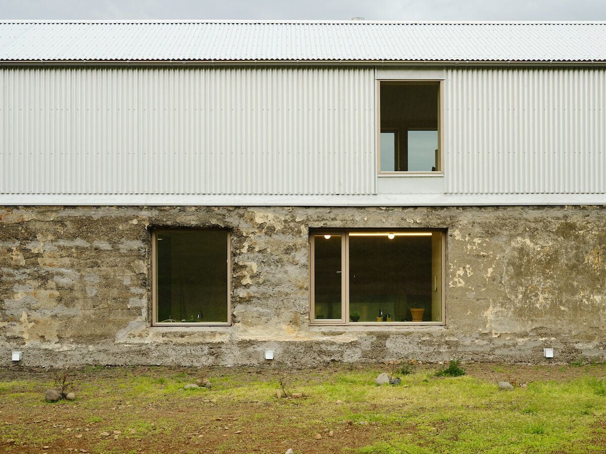 A closer look at the renovated barn clearly shows where the original concrete structure ends and the new upper-level steel structure begins 