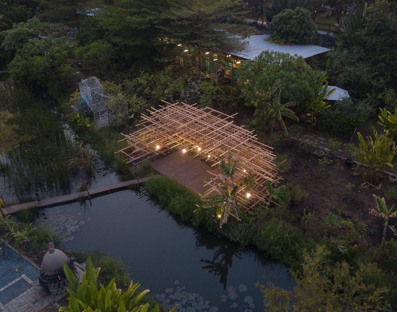 Nighttime aerial view of MIA Design Studio's minimalist Straw Pavilion in Ho Chi Minh City, Vietnam.