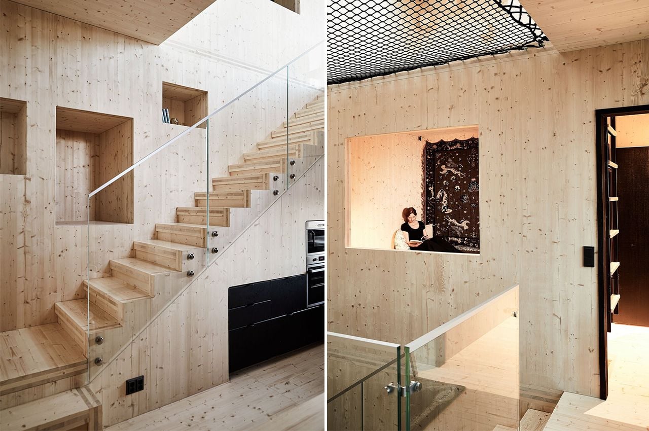 Cozy minimalist stairway and reading nook inside Finland's stark black Meteorite cabin.