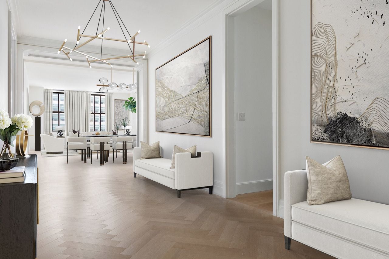 Sleek lighting fixtures, white interiors, and refined oak floors make up the interior palette of Condo 20B at the historic 100 Barclay Street.