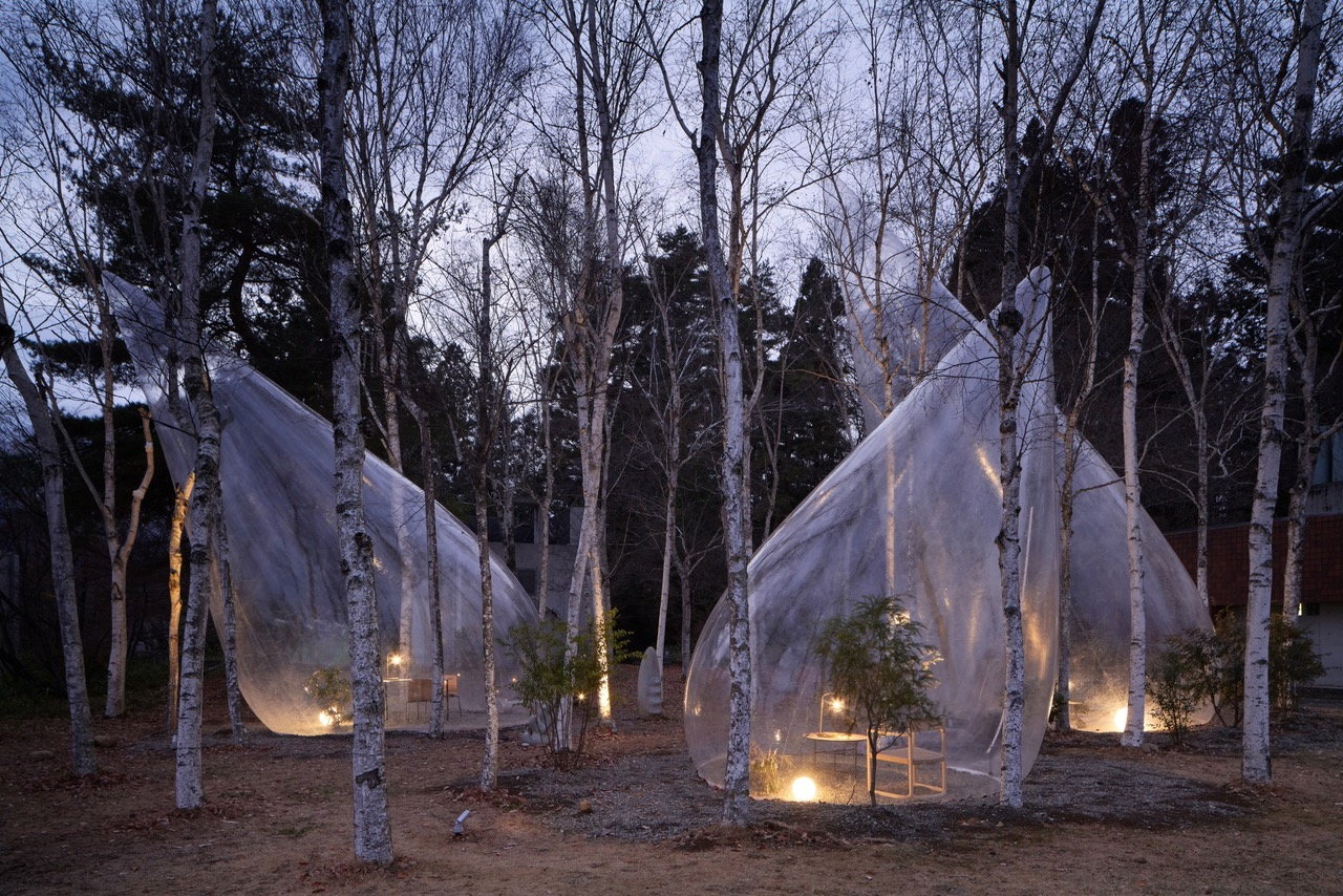 Nighttime view of Yuko Nagayama Associates' translucent teardrop-shaped tents.