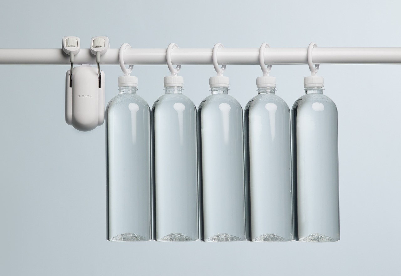 Hanging water bottles on a SwitchBot Smart Curtain Rod show just how strong the little device actually is.