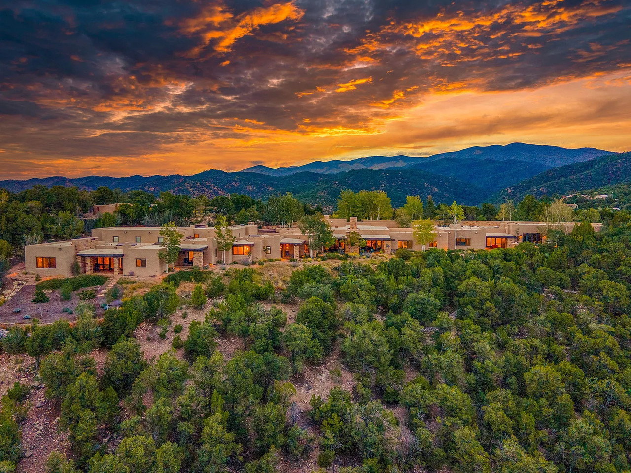 Exterior view of 1432 Old Sunset Trail, a sprawling adobe mansion in Santa Fe, New Mexico on the market for $8.5 million.