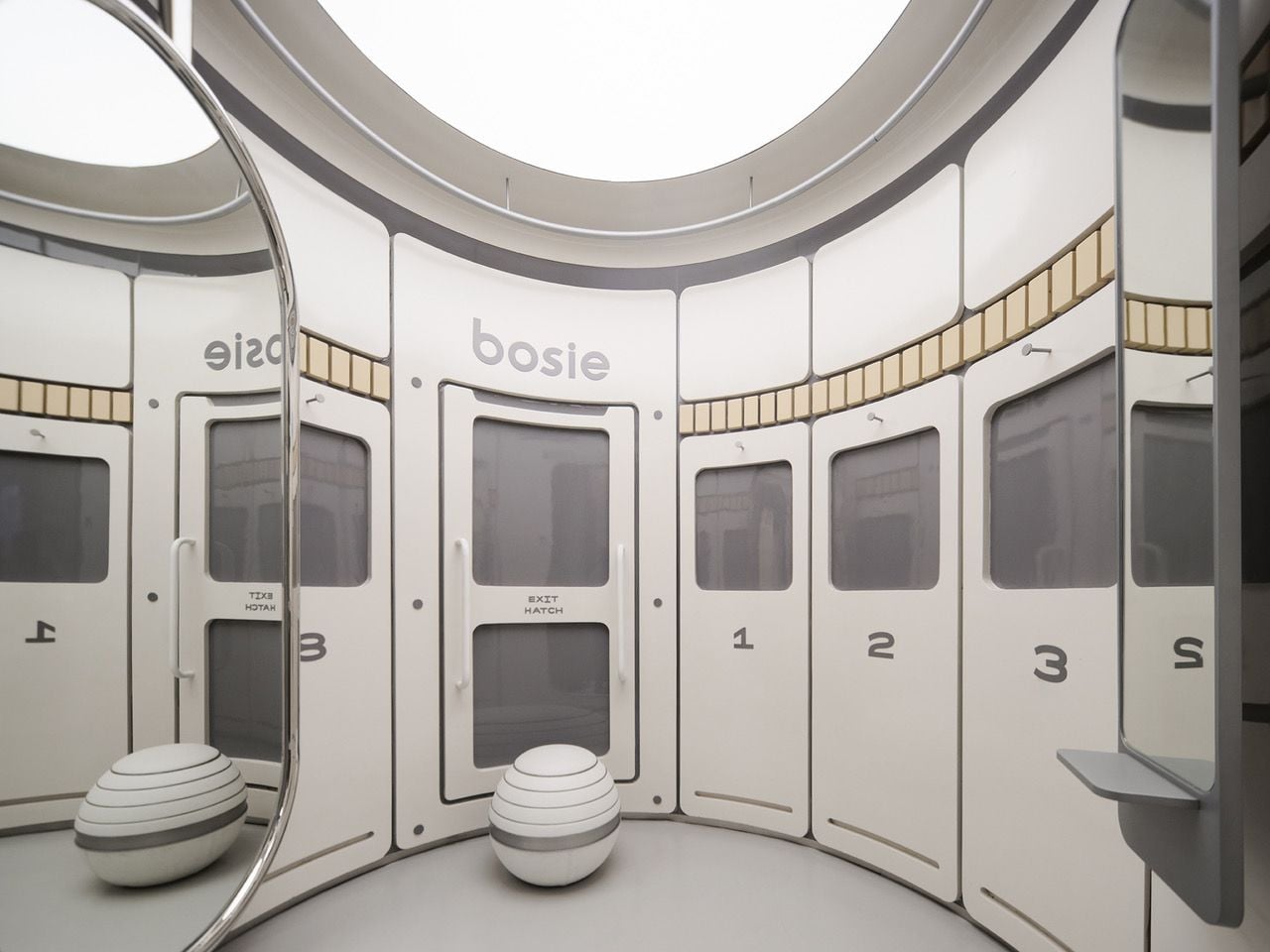 Capsule-like fitting rooms in Bosie's spaceship-themed Shanghai retail store.