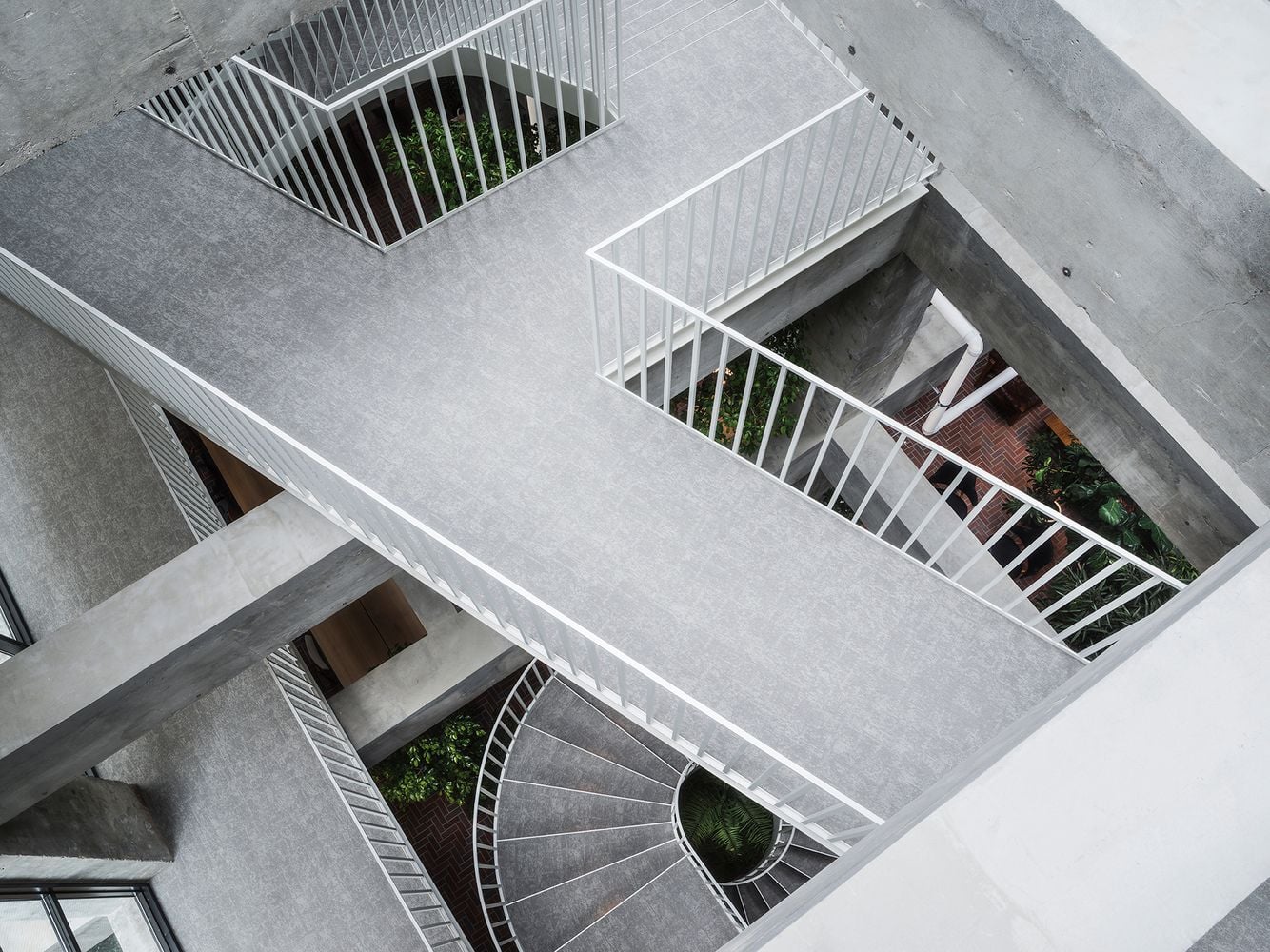 Walkways and spiral staircases connect the atrium to private guest rooms above.