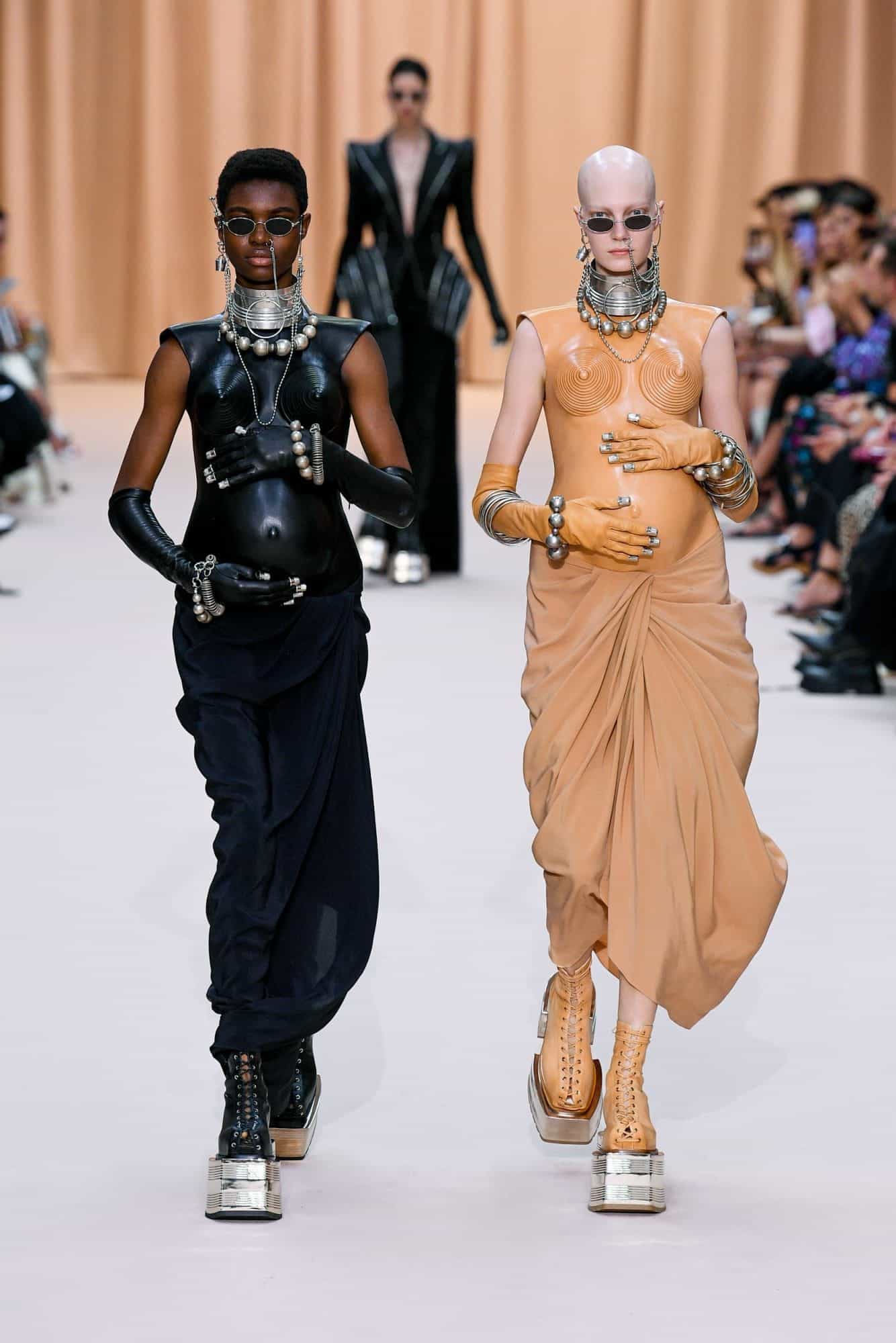 Pregnant Gaultier models sport combat-style boots at Paris Fashion Week 2022.