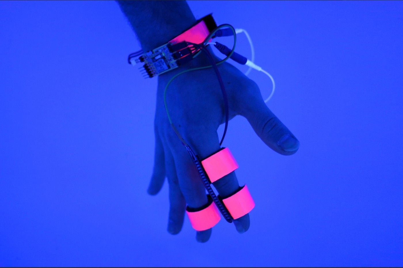 A person's hand wrapped in the sensors that make up MIT's new dream-altering Dormio technology.