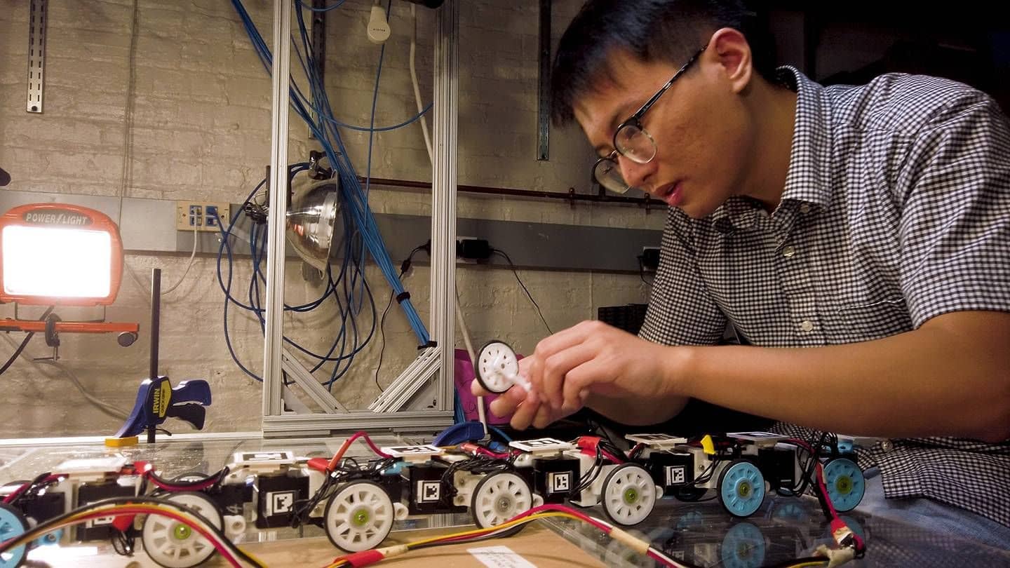 Researcher Chen Li works hard on a robotic snake prototype.