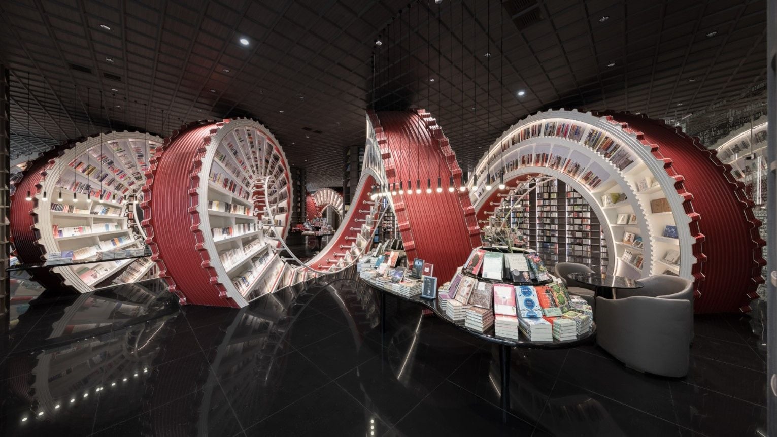 Massive sculptural spiral bookcase runs through the center of the X+Living-designed Shenzhen Zhongshuge bookstore.