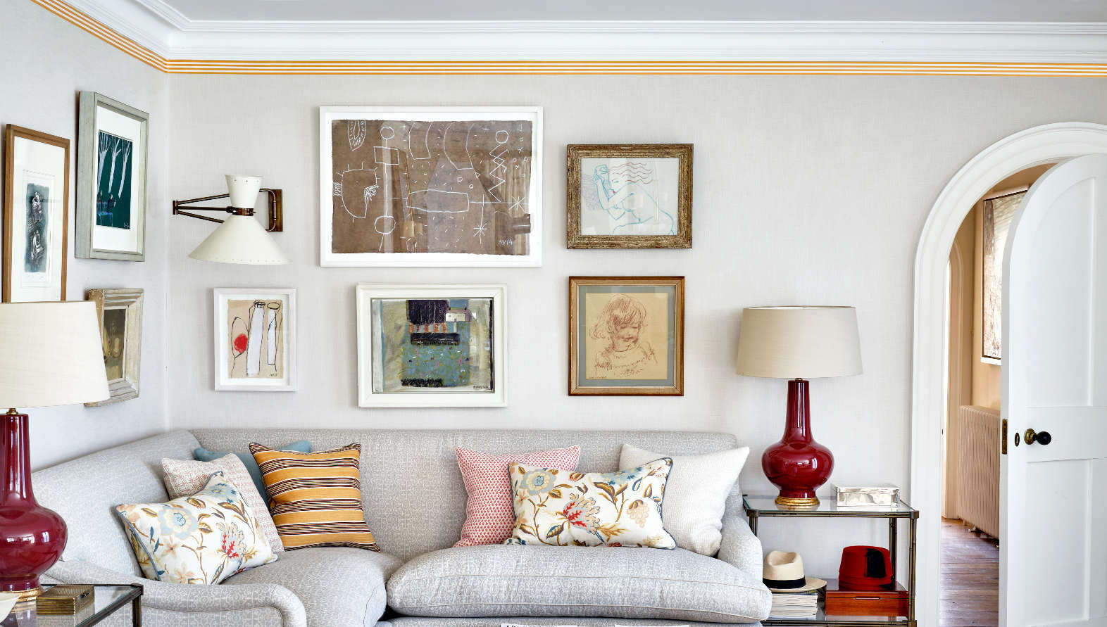 Colorful yellow wallpaper border adds a splash of color to a mostly neutral living space. 