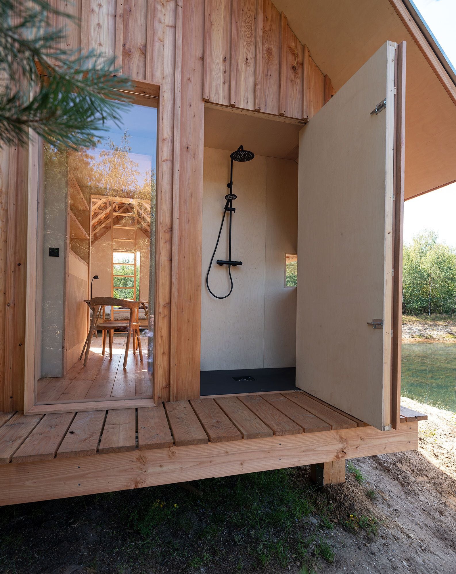 A cozy shower hides inside one of the ANNA Cabin's sliding wooden walls.