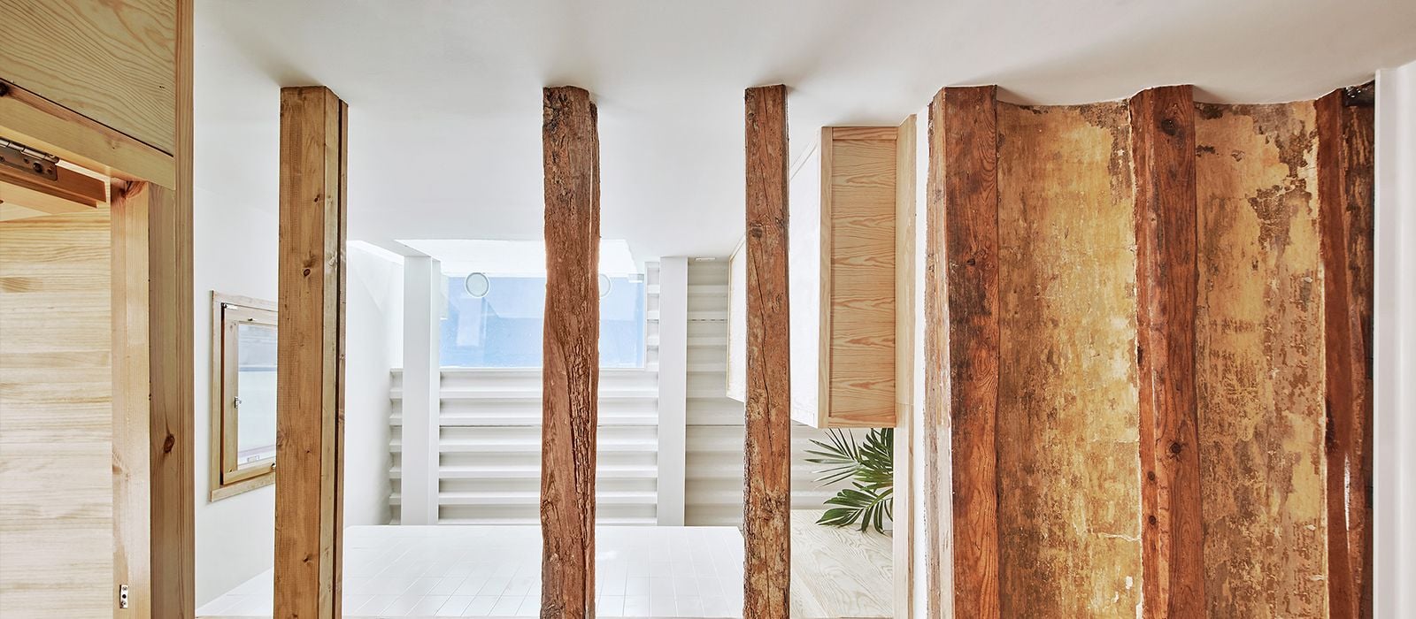 Exposed wooden beams add a rustic touch to the Twobo-restored 5x5-meter home in Barcelona. 