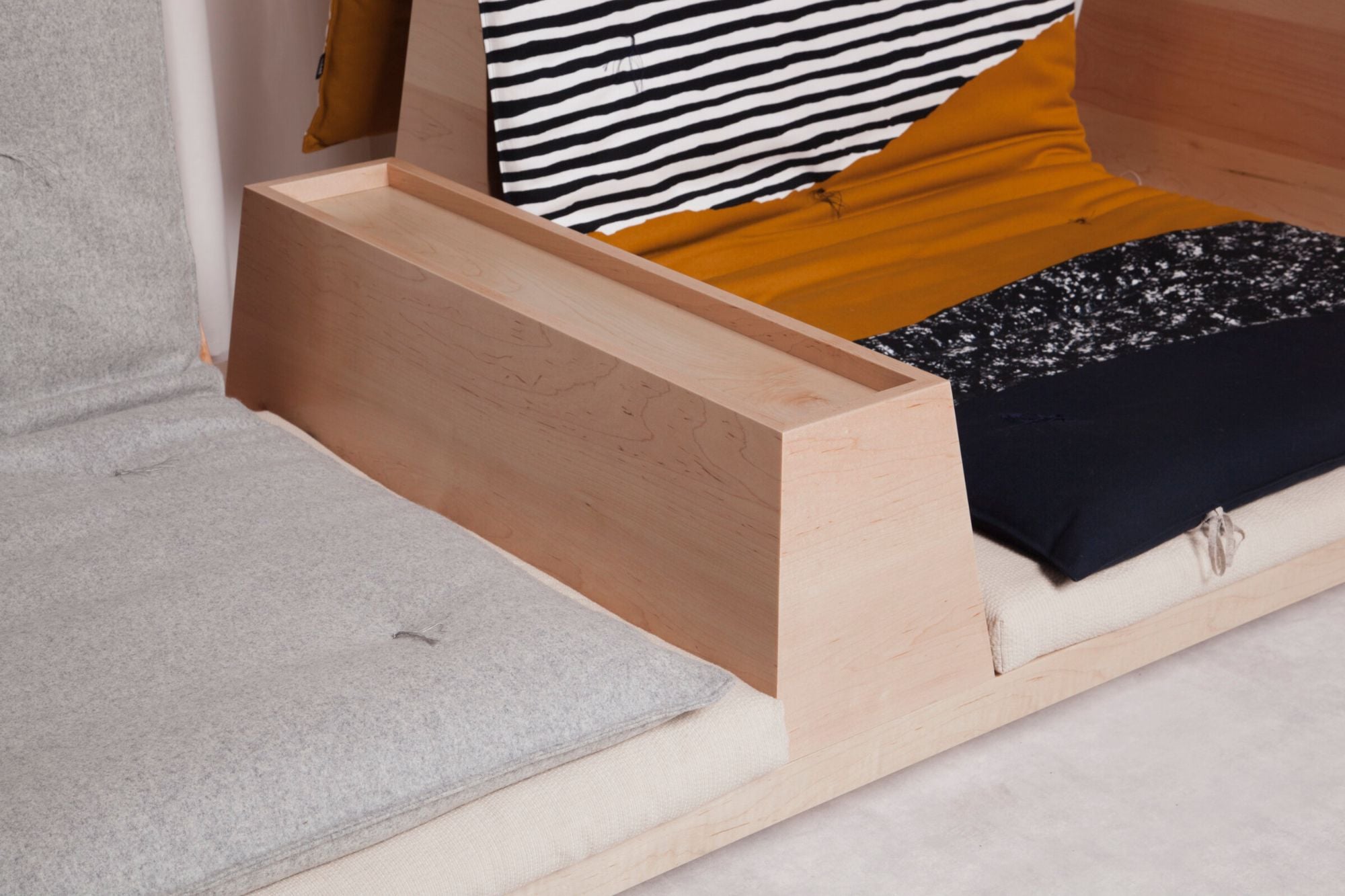Close-up of the Zabuton's wooden and futon elements, with a handy low-table partition installed in the center. 