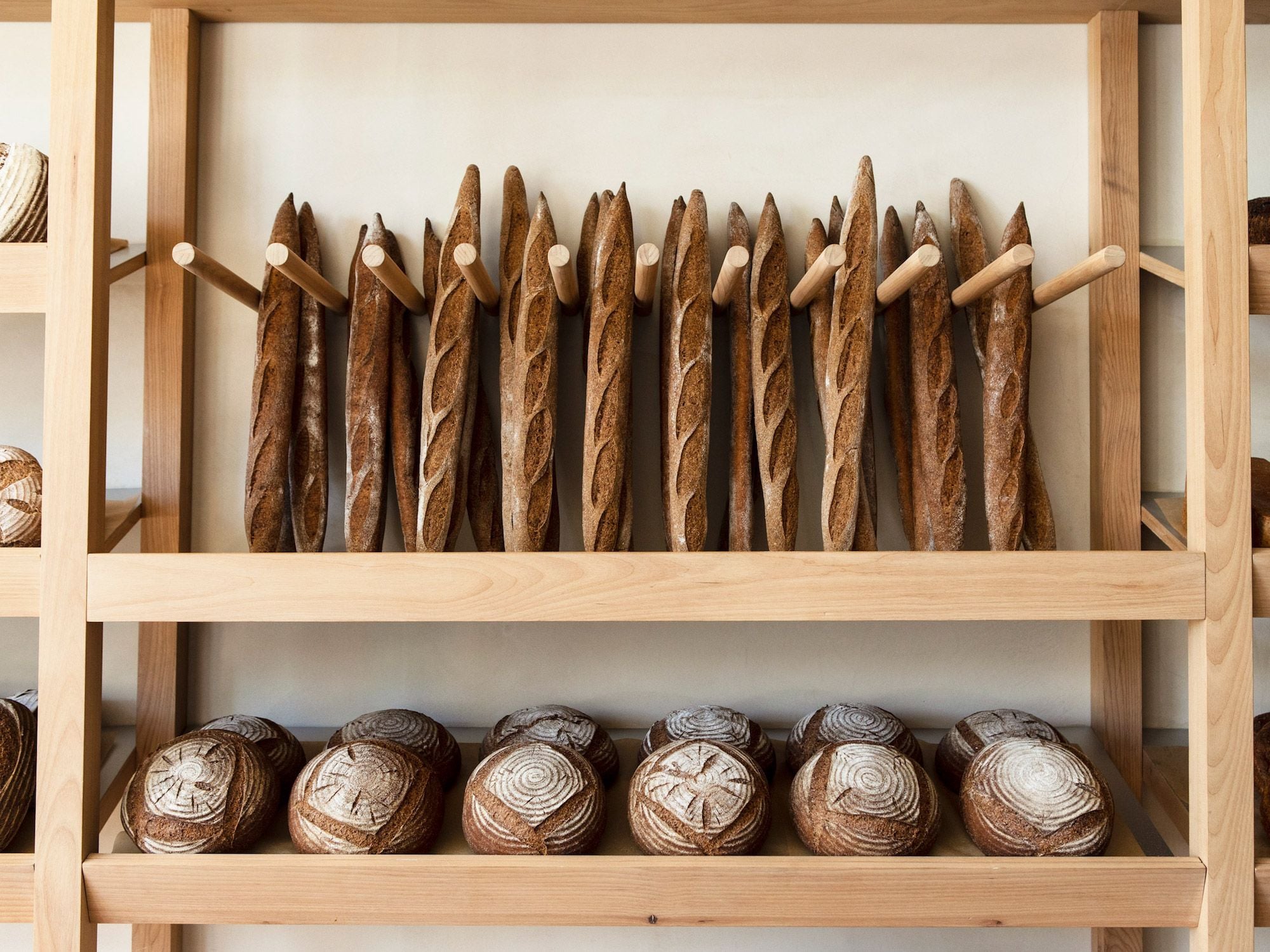 Behind the main counter at Breadblok, simple wooden elements keep inventory nice and neat.