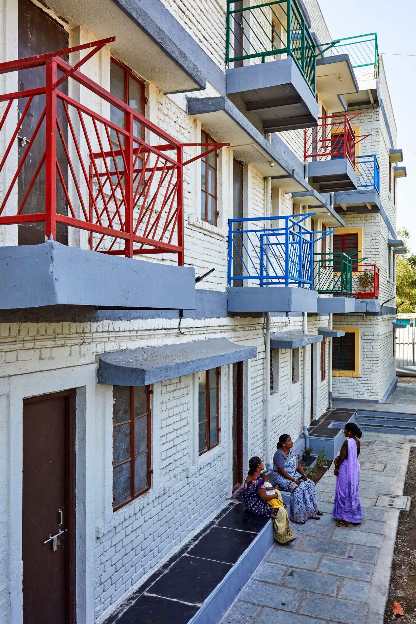 Colorful metal railings line the balconies of the CDA's revitalized Sanjaynagar housing units.
