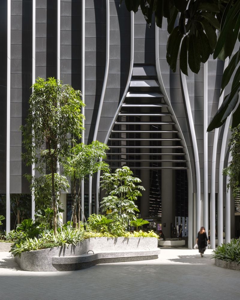 Street-level entrance to Singapore's biophilic CapitaSpring skyscraper. 