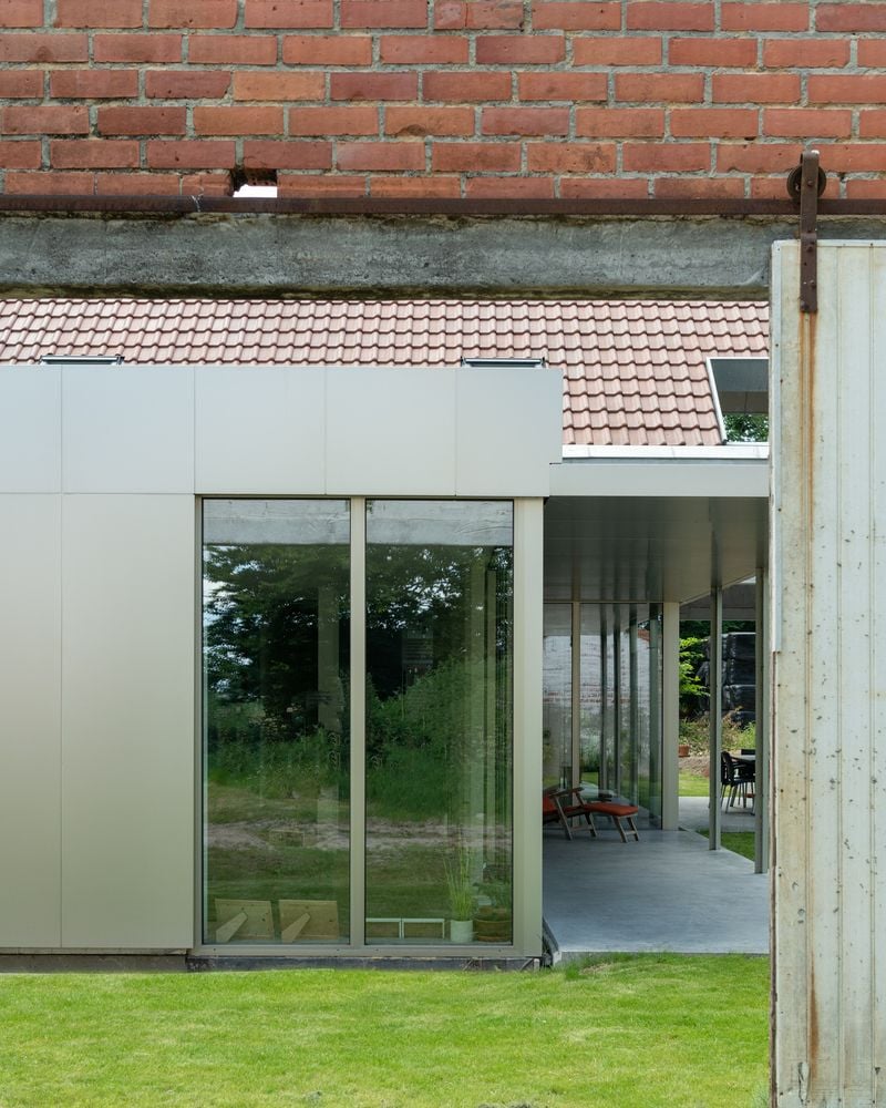 Traditional and contemporary materials collide at the renovated Old & New farmhouse in Belgium.