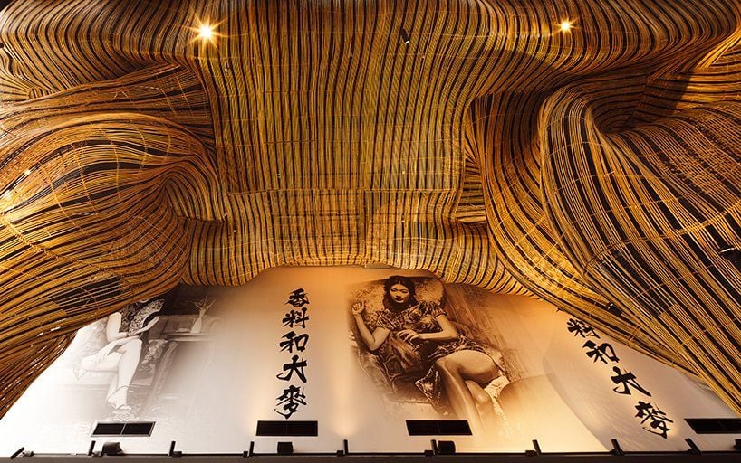 Upward view at the restaurant's swirling rattan ceiling.