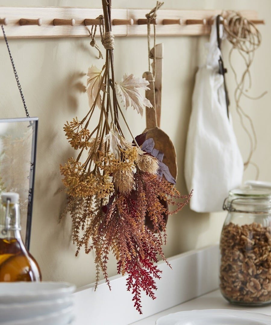 IKEA's fall 2021 Höstkvall artificial bouquet hangs from a kitchen wall.