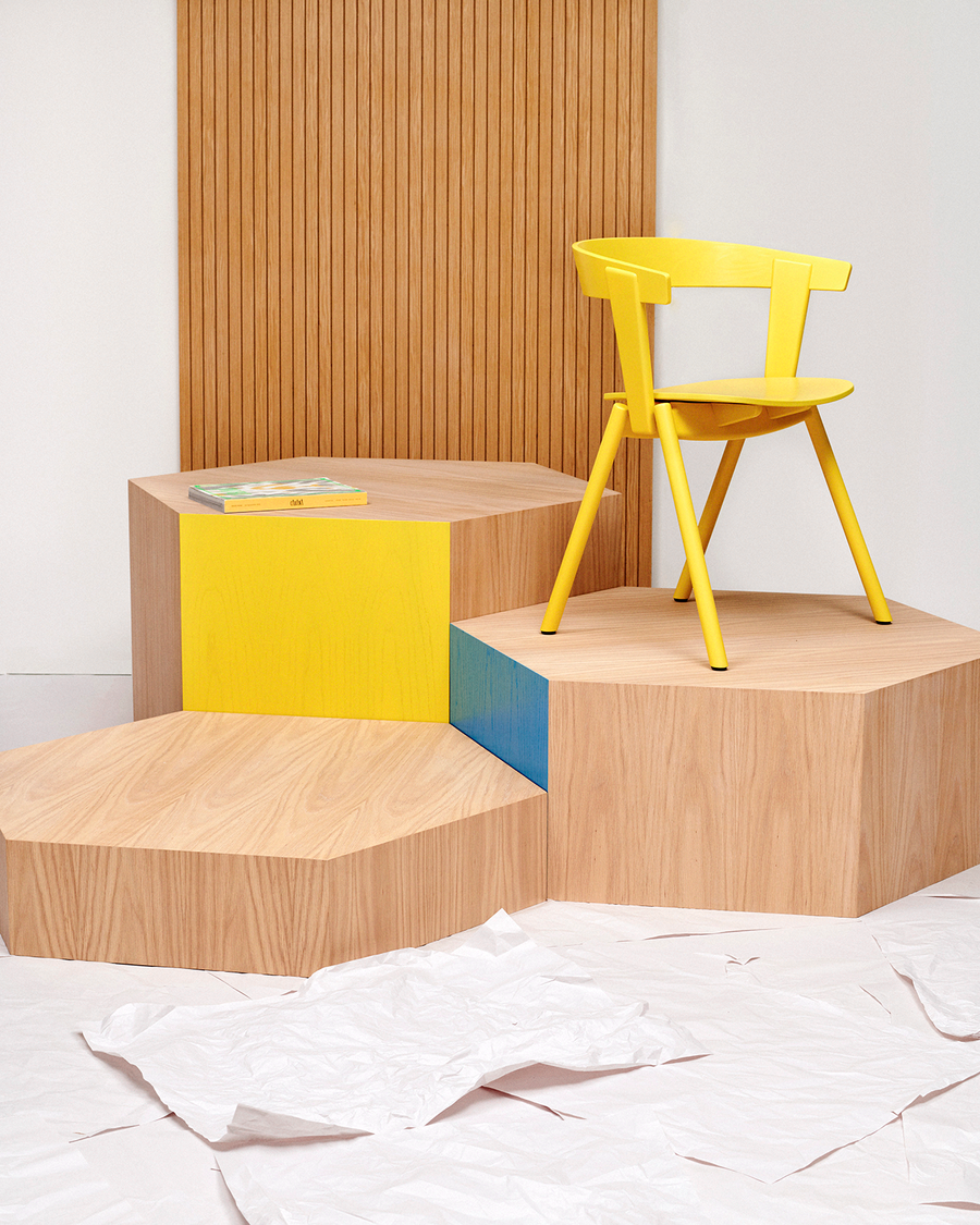 Oku Space's stackable OS1 chair displayed on a timber pedestal.