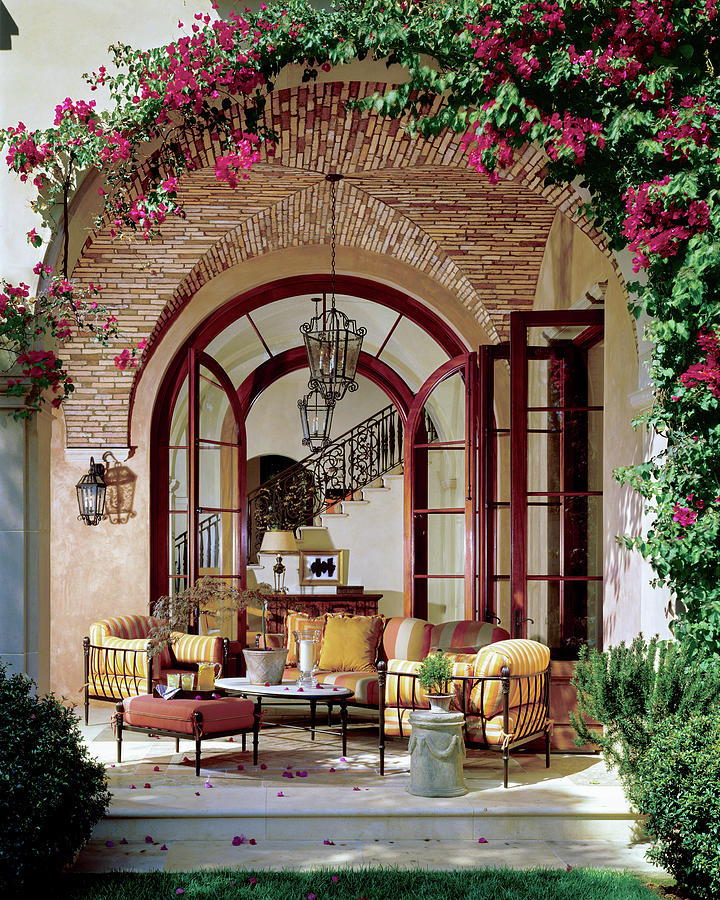 Tuscan-style patio space underneath a large archway.