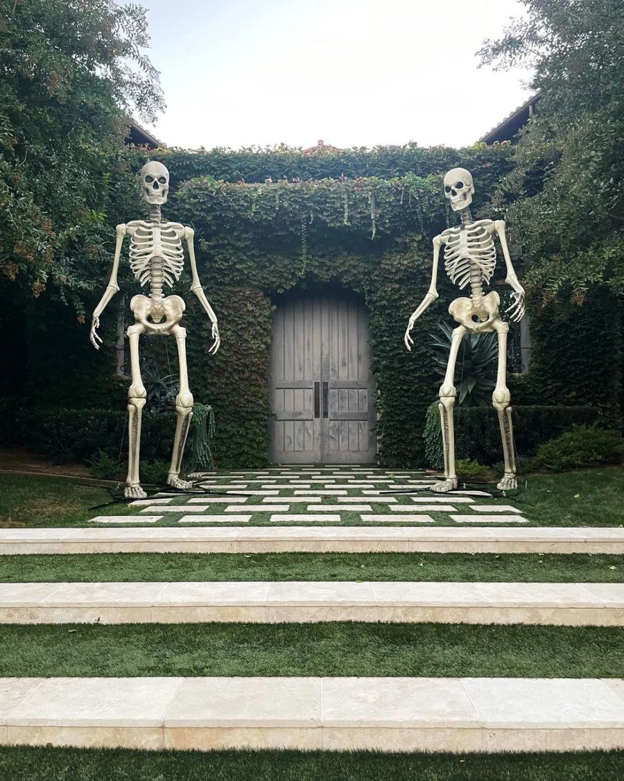 12-foot-tall plastic skeletons guard Kourtney Kardashian's garden gate.