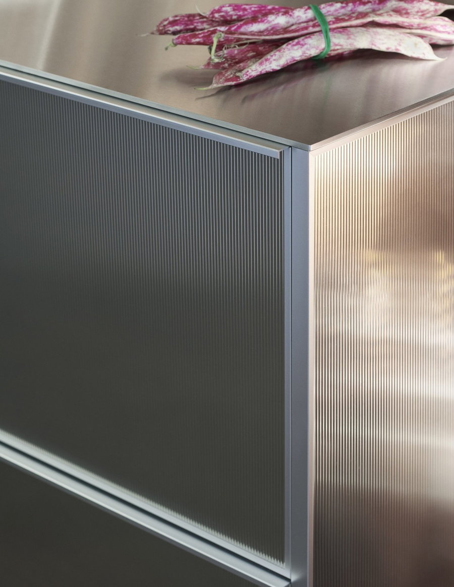 Close-up view of the reflective facades of Nouvel's stainless steel kitchen cabinets for Reform.