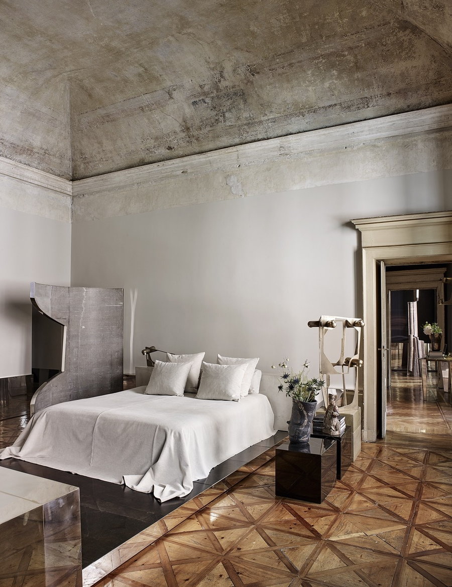Plaster-heavy bedroom area inside Vincenzo De Cotiis' renovated Milan palazzo.