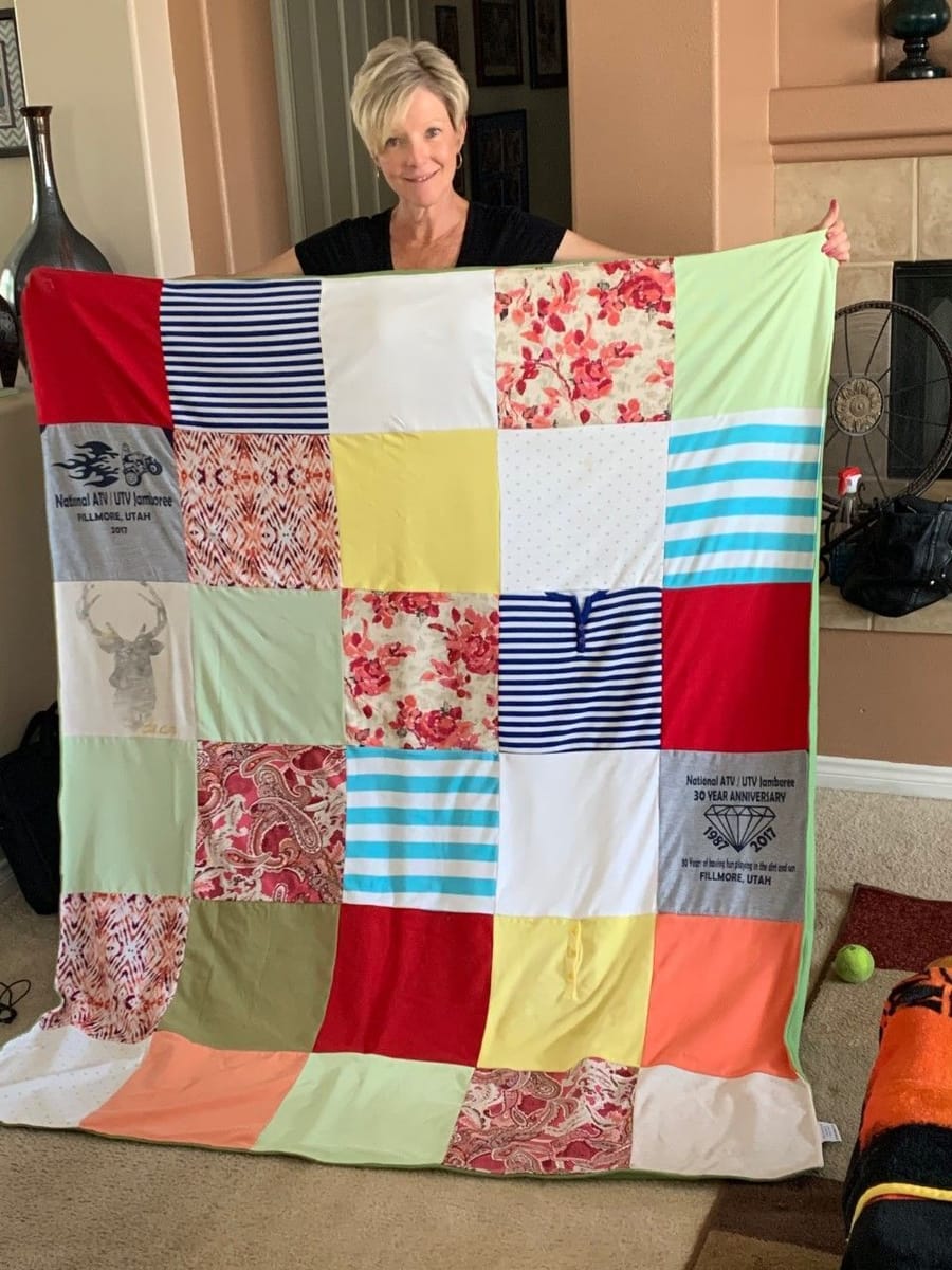 Proud mom shows off her memory quilt for the camera. 