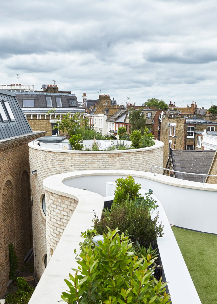 A rooftop garden rests atop the castle-like turrets of Alex Michealis' Round House