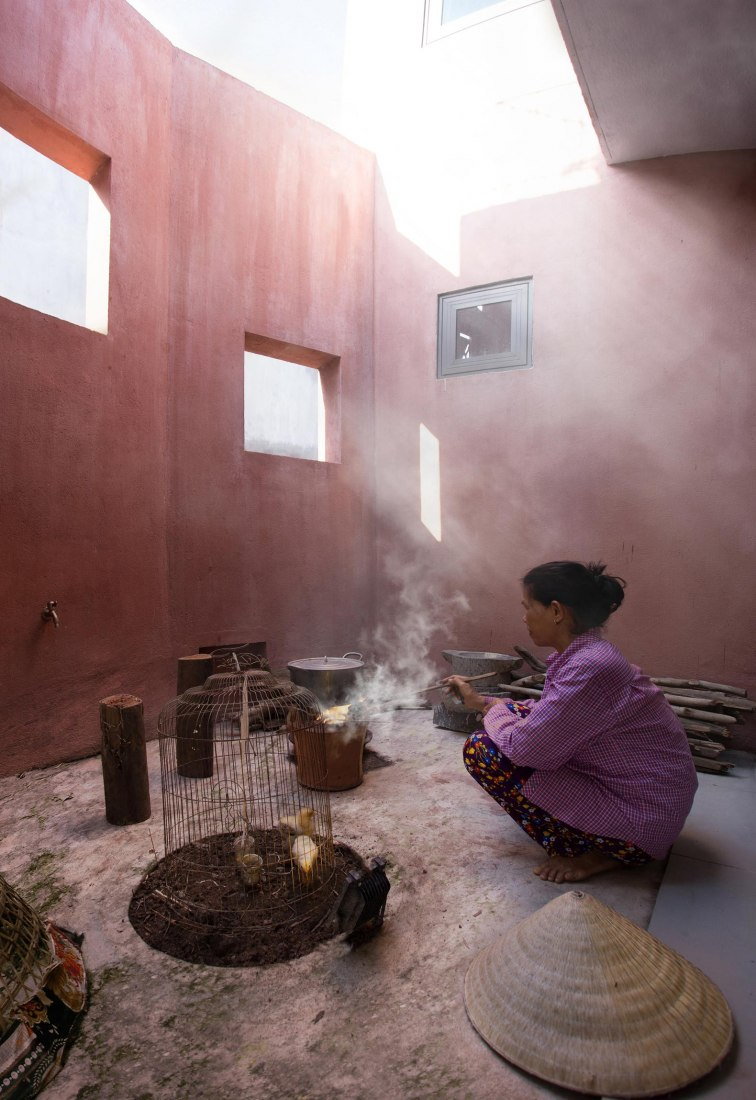 An older woman is hard at work in one of the Red Roof's many transitional courtyard spaces. 