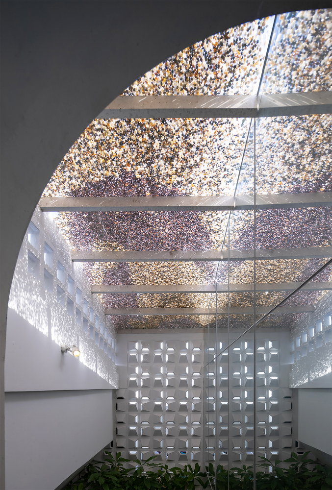 Mirrors and shimmering skylight create ethereal spaces like this one all throughout the Coco House.