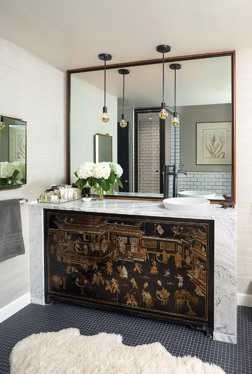 Designer Andrea Schumacher turned an old chinoiserie cabinet into a washstand with the addition of a marble waterfall top.