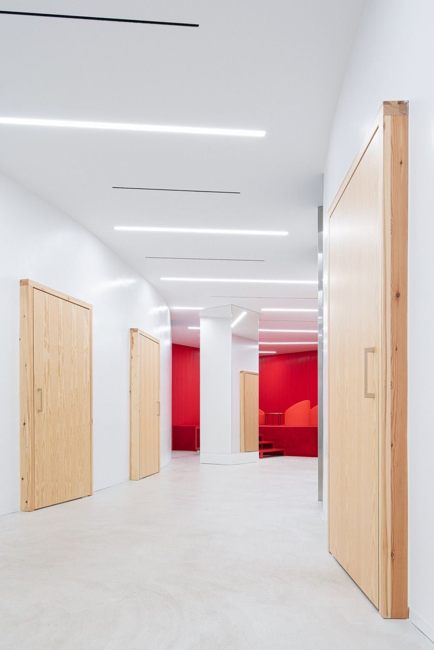 Thick pine doors in the clinic's curving walls lead to exam rooms outside the main 