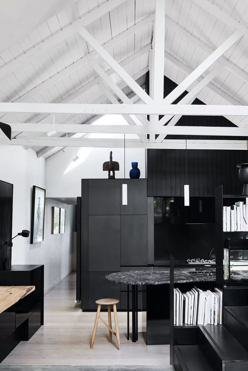 Modern black and white spaces dominate the inside of the Splinter Society architects' spiky black home. 