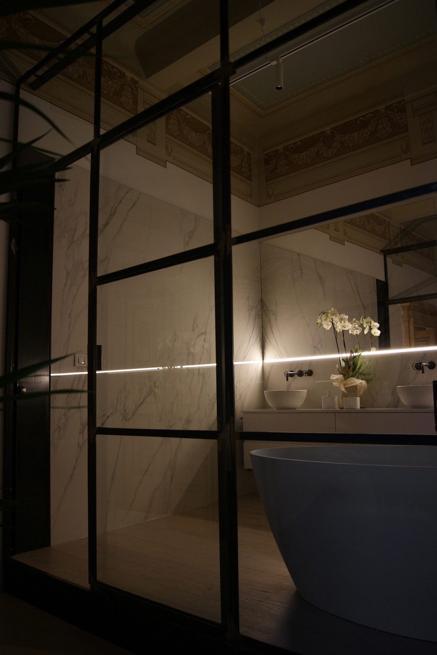 Modern bathroom inside the renovated Lelefante apartment emits a seductive glow in the dark. 