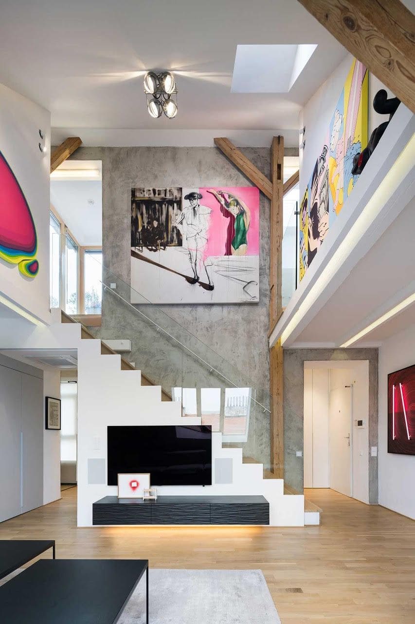 The Art Maisonette multiple artworks displayed above the apartment's main staircase